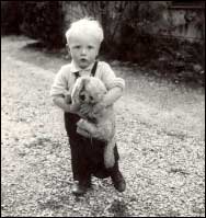 Young Boy Holding Toy Dog