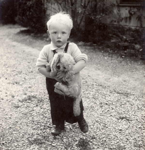 Young Boy Holding Toy Dog 